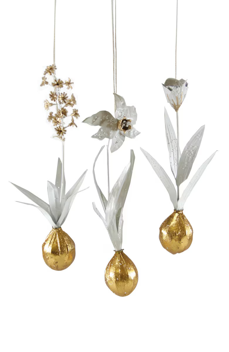 Gold & white holiday ornaments in the form of blooming tulip, hyacinth, and daffodil bulbs.