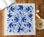 A cotton flour sack towel with an allover pattern featuring blue songbirds.