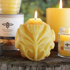 "Flora"-a spherical beeswax votive with an allover carved floral design.