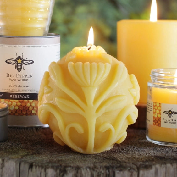 "Flora"-a spherical beeswax votive with an allover carved floral design.