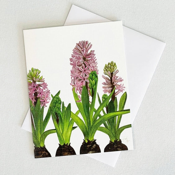 Bulb & Blossom's Hyacinth Notecard features a watercolor illustration of pink hyacinths with green foliage and bulbs, printed on linen-textured cardstock and blank inside