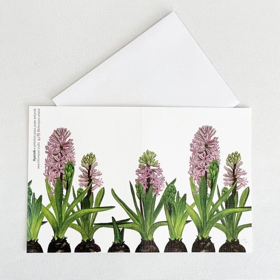Bulb & Blossom Hyacinth Notecard featuring watercolor artwork of pink hyacinth blooms and green leaves emerging from bulbs.
