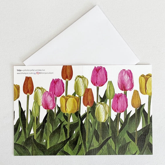 Bulb & Blossom Tulip Notecard featuring a watercolor illustration of multicolored tulips in full bloom, wrapping around the front and back of the card.