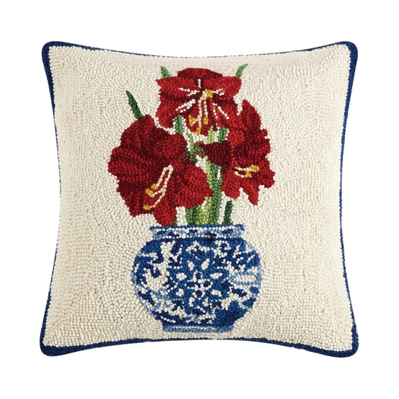 A woolen needle hook throw pillow featuring a chinoiserie vase filled with amaryllis blossoms.