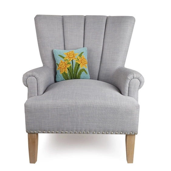 A woolen needle hook throw pillow featuring daffodil flowers.