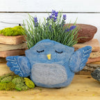 A woolen felted pot cover in the form of a bluebird.