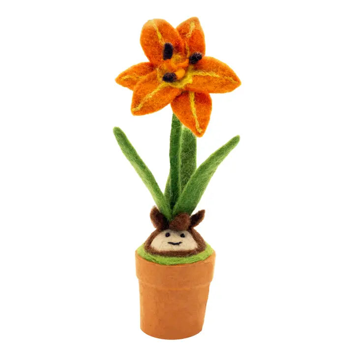 A hand felted lily blossom in a small paper pot with a smiling bulb.
