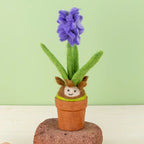 Cheerful felted blooming hyacinth bulb in a paper pot.