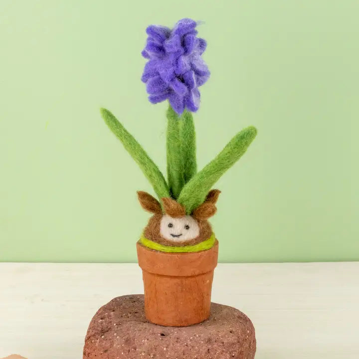 Cheerful felted blooming hyacinth bulb in a paper pot.