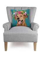 A square decorative throw pillow featuring a colorful embroidered-style dog portrait with a floral crown on a teal background, displayed on a light gray upholstered armchair.