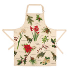 A cream-colored apron featuring a vintage botanical illustration print of Christmas plants, including poinsettias, holly, mistletoe, pinecones, and sprigs with handwritten labels, shown against a plain white background.