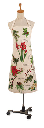 A cream-colored apron with a festive botanical print of red poinsettias, holly leaves, pine branches, and mistletoe, displayed on a mannequin stand.
