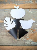 Three shapes of black sticky gnat trap are displayed, an apple, a bird, and a monstera leaf.