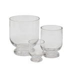 The sturdy Hollis Forcing Vase is clear glass with a pedestal foot and comes in three sizes.