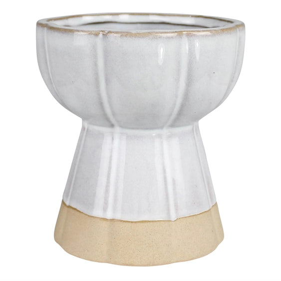 The Koma Ceramic Bulb Forcing Vase features a glossy white upper half, a textured beige base, vertical ridges, and a flared silhouette that narrows at the center.