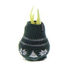 A waxed amaryllis bulb with a sweater covering in dark green with white nordic-style pattern. Green amaryllis buds emerge from the neck of the bulb.