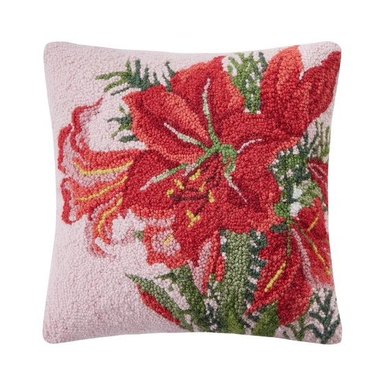 A woolen needle hook throw pillow in pink featuring large red amaryllis blossoms and foliage.