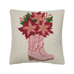 A woolen needle hook decorative pillow featuring pink cowboy boots filled with red amaryllis blooms.