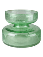 A translucent light green glass vessel with a wide, rounded base and a smaller, flared rim on top, shown against a plain white background.