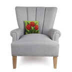 A woolen needle hook throw pillow featuring red tulip blooms.