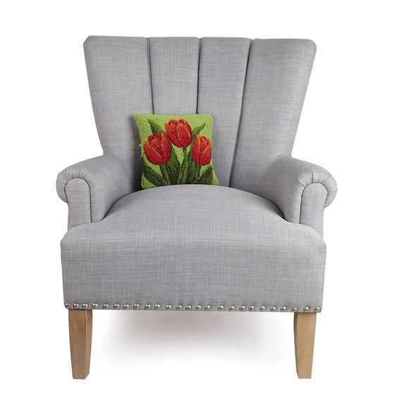A woolen needle hook throw pillow featuring red tulip blooms.