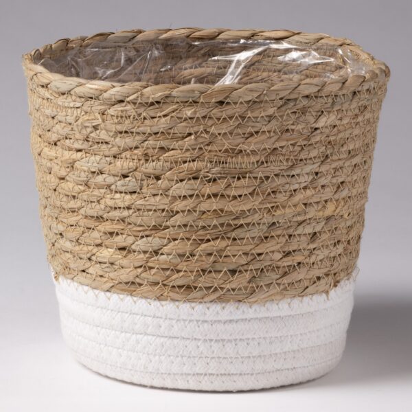 A woven wicker basket with a plastic liner inside. The basket features natural-colored wicker in the upper section and white woven material in the lower section. The design is simple and rustic, suitable for decorative purposes or storage.