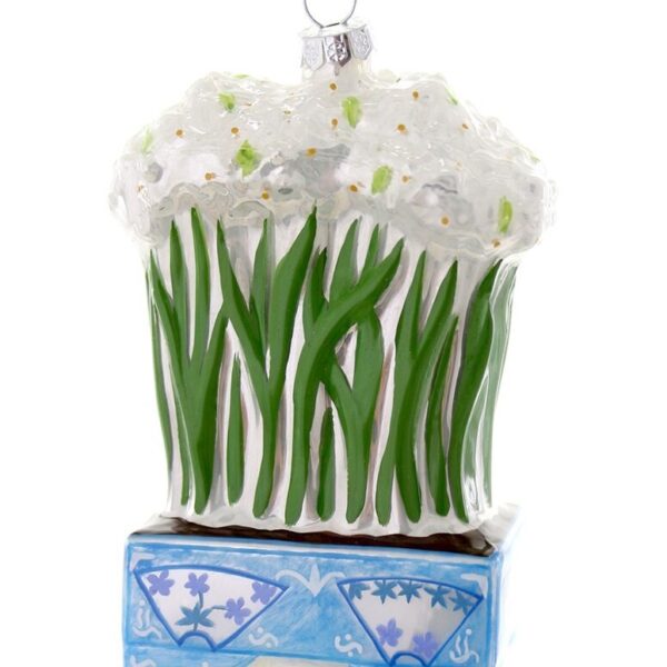 A glass ornament in the form of a chinoiserie planter holding blooming paperwhite narcissus.